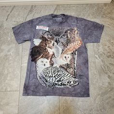 Questions? Leave A Comment Below! This The Mountain Find 11 Owls T-Shirt Is Perfect For Nature Lovers And Animal Enthusiasts. The Shirt Features A Beautiful Multicolor Tie-Dye Design With An Owl Theme, Making It A Great Addition To Any Wardrobe. It Is Made Of 100% Cotton And Is Machine Washable For Easy Care.The Shirt Is Available In An Adult Size Medium And Has Short Sleeves, Making It Ideal For Warm Weather. It Is Suitable For Both Men And Women And Can Be Worn For A Casual Day Out Or For A Ni Mountain Tee Shirt, Nature Themed Gifts, Mountain Shirts, Giraffe Shirt, Thrift Inspo, Owl Shirt, Owl T Shirt, Owl Theme, Wolf Shirt