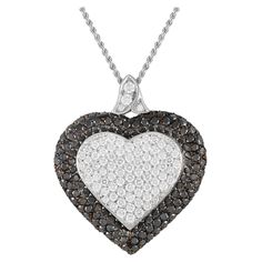 This exquisite creation by Graff is a testament to the British jeweler's exceptional craftsmanship and the high quality of its diamonds. The necklace features a heart-shaped pendant measuring 1.75 inches by 1.5 inches, decorated with a combination of 2.02 carats white diamonds and 4.03 carats black diamonds - all in pav setting. With an alluring beauty that is as clear as black and white, make sure you do not miss out on the chance to own this masterpiece.This Graff 18K White Gold 6.05ct Diamond Pave Heart Necklace is offered in estate condition, inclusive of a pouch. Pave Heart Necklace, Black Diamonds, White Diamonds, Pave Diamonds, Black Diamond, Diamond White, Heart Necklace, Jewelry Necklace Pendant, White And Black