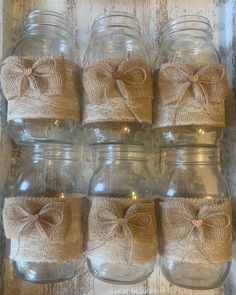 mason jars with burlocks and bows on them