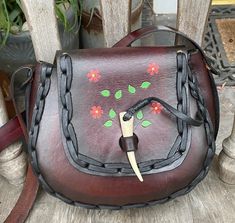 This is a smaller vintage hippie leather saddle shoulder bagit was all reconditioned and relaced and a new strap was added.... the leather is in good condition and the measurements are 7 inches wide,  9 inches tall, the gusset is 3 inches and the shoulder strap drop is  18 inches....the flap closure is a deer antler peg... there are a few red flowers and green leaves tooled to the flap and the front of the bag Bohemian Saddle Bag Satchel With Adjustable Strap, Vintage Hippie, Deer Antler, A Deer, Boho Festival, Saddle Bag, Red Flowers, Saddle Bags, Green Leaves