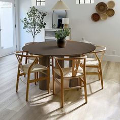 a table and chairs in a room with white walls