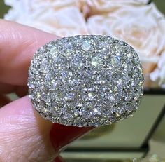 a close up of a person holding a diamond ring