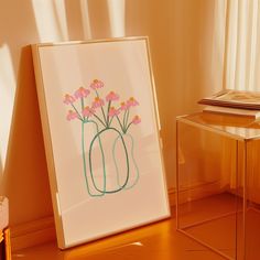 an art work with pink flowers in a vase next to a small table and chair