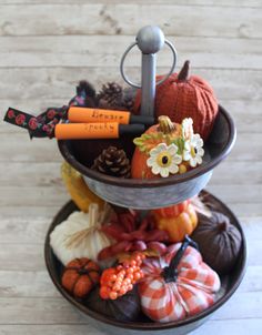 three tiered trays filled with fall decorations