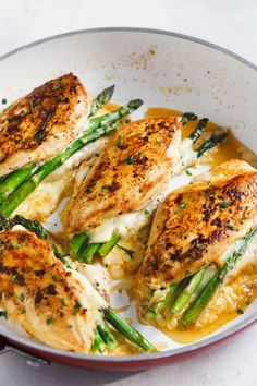 some chicken and asparagus on a white plate