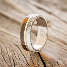 a wedding ring with wood and silver inlays