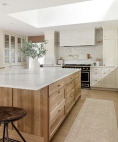 a large kitchen with an island and stools