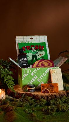 an assortment of soaps, candles and other items in a box on a table