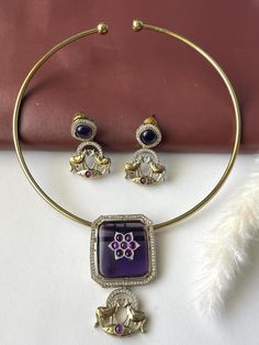 Get ready to collect tons of compliments for this unique hasli piece . Antique gold plated , this is a lightweight jewelry.  Comes with matching earrings . Stunning necklace set for this festive season , Simple classy elegant! The purple pendant is almost 1.25 inches . Easy to wear . Earrings : 1.25 inch long Hasli Necklace, Purple Pendant, Light Weight Jewelry, Earrings Trendy, Stunning Necklace, Festive Season, Matching Earrings, Festival Season, Antique Gold