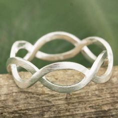 Ribbons of brushed sterling silver intertwine moving together in harmony. Always creative Sarote Lochotinunt crafts a band ring with a clean modern style. Silver Band Ring With Cut Out, Silver Rings Handmade Not On The High Street, Cheap Handmade Traditional Rings, Simple Silver Jewelry, German Silver Jewelry, Stacker Rings, Jewelry Quotes, Silver Jewelry Earrings, Silver Jewelry Design