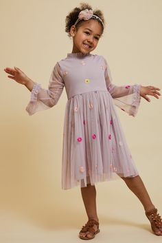 Polka-dotted with colourful embroidered flowers, Elodie is a simply charming piece. Realised in a dusky blush, this style is complete with gently flaring full length sleeves and ruffled trim at the neckline and cuffs. Amelia Rose, Frock And Frill, Floral Embroidered Dress, Embroidered Neckline, Embellished Dress, Amelie, Girls Dress, Fall Winter Outfits, Embroidered Dress