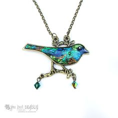 "Patchwork bird pendant. Features a mixed media collage of beautiful peacock shades, set in a silver bird shaped pendant. A glossy topcoat of resin adds depth to mimic a dichroic glass appearance. Premium crystals add that extra sparkle. Each design is handmade and will differ slightly - so you will be getting a one of a kind! Your item will sparkle beautifully under light. Available in silver or bronze surround with matching chain. SIZING Chain length: 35.5cm (14\") Extender length: 5cm Approx Bohemian Peacock Necklace For Gift, Bohemian Peacock Necklace As Gift, Handmade Bird-shaped Jewelry For Gifts, Handmade Bird-shaped Jewelry Gift, Handmade Peacock Jewelry Gift, Unique Bird Design Pendant Jewelry, Handmade Peacock Color Jewelry As Gift, Handmade Peacock Jewelry As Gift, Green Bird Design Jewelry Gift