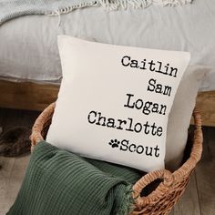 a pillow that says, cattin sam logan charlotte scott on it sitting in a wicker basket