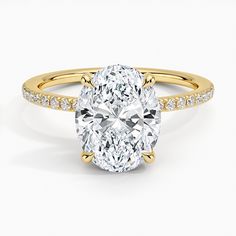 an oval cut diamond ring with pave set shoulders