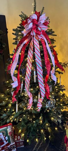 a christmas tree decorated with red, white and blue ribbons