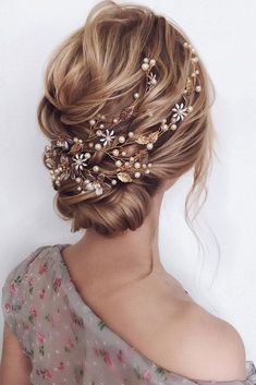 a woman wearing a hair comb with flowers on it