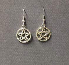 Handmade silver plated pentagram charm earring. A classic for every dark lady. Choose your metal type ear hook and I will make one just for you. Product details Pentagram charm is silver plated; Your choice of ear hook, sterling silver or silver plated. nickel free 1 1/2 inches long total VISIT MY SHOPS HERE * http://www.etsy.com/shop/HappyCatHouse * http://www.Etsy.com/shop/AnEnchantingCreature CONNECT * http://www.facebook.com/EnchantingCreature * https://instagram.com/enchantingcreature * htt Gothic Star-shaped Pierced Earrings, Gothic Silver Star Earrings, Silver Star Gothic Earrings, Silver Witchy Earrings, Gothic Star-shaped Metal Earrings, Gothic Star Shaped Metal Earrings, Silver Witchy Pierced Earrings, Nickel Free Sterling Silver Witchy Earrings, Nickel-free Sterling Silver Witchy Earrings