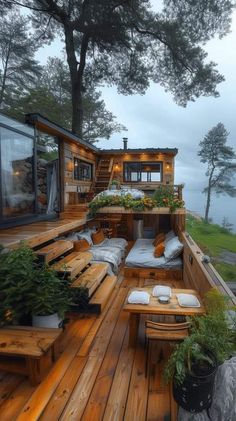 a wooden deck with benches and plants on it