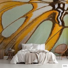 a bedroom with a large butterfly wall mural