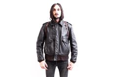 ⚜  Description  ⚜ Lovely A-2 Flight Leather Jacket  From SCHOTTMADE IN USA Quilted Interior. Thick Robust Leather Shell Talon Heavy Duty Zipper and snap closing System Estimated Size is Medium. Size on Label is 44 100% Leather Good Vintage Condition! ⚜  Measurements  ⚜  Armpit to Armpit: 64 cm or 25''  Sleeve (From Shoulder Seam to end of cuff): 64 cm or 25' Shoulder to Shoulder: 50cm or 20 '' Overall Length From Shoulder to bottom hem: 68 cm or 27 '' B1766 Vintage Outdoor Biker Jacket With Zipper Closure, Vintage Biker Jacket With Zipper For Outdoor, Vintage Biker Jacket With Zipper Closure For Outdoor, Vintage Biker Jacket For Streetwear With Zip Detail, Vintage Outerwear With Ykk Zipper For Fall, Vintage Biker Jacket With Zipper For Streetwear, Retro Leather Jacket With Pockets For Streetwear, Aviation Jacket, Usa Quilt