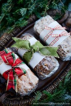 three wrapped presents sitting on top of a tray