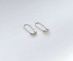 These earrings can be worn as a single earring or as a pair. They have the 925 sterling silver stamp on one side of the safety pin's head. These earrings are light pieces and hook comfortably through the ear. M A T E R I A L Hypoallergenic High-Quality Solid 925 Sterling Silver ( 18K Gold Plated / White Gold Plated) S I Z E Approx. Length 0.75 in / 19mm Sterling Silver Clip-on Earrings For Everyday, Sterling Silver Clip-on Earrings Set For Everyday, Safety Pin Shaped Earrings With Ear Wire, Minimalist Sterling Silver Clip-on Hoop Earrings, Sterling Silver Paperclip Earrings As Gift, Safety Pin Earrings As Gift, Silver Safety Pin Shaped Earrings For Gift, Silver Safety Pin Earrings As Gift, Silver Safety Pin Earrings For Gift