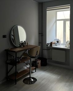 an empty room with a desk and mirror