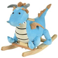 a blue and white stuffed dragon sitting on a wooden rocking toy with one foot in the air