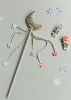 Wave your magical moon wand and imagine the moon and stars appearing! In gorgeous gold glitter fabric adorned with brightly coloured star streamers, this is the perfect wand for magical spells, imagination adventures, or a fun addition to the dressing up box! Matching clips and bag also available. Made using recycled glitter and ribbon. Not suitable for children under 36 months due to small parts. Magic Wand Craft Preschool, Christmas Wands Diy, Christmas Wands, Magic Wand Craft, Magical Spells, Magical Moon, Ceremonial Clothing, Ribbon Wands, Star Wand