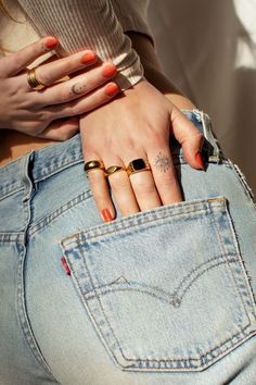 a woman with two rings on her left hand and one ring in the back pocket