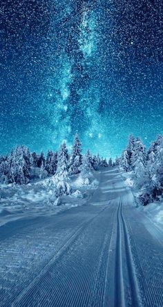 the night sky is filled with stars and snow as it shines brightly in the distance