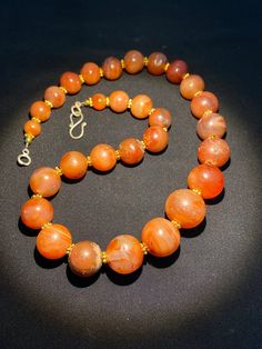 The beautiful orange color carnelian beads necklace from Himalaya Nepal This beads were used in prayer malas and used as jewelry and amulets in ancient times very smooth and shinny surface of this beads because of passage of time and usage of this beads in prayers mala and in necklace The age of this beads are more than 1000 years small size gold color brass beads are used as spacers in the necklace we provide fast and free shipping service to our customers by which can get the items by maximum Orange Carnelian Necklace In Spiritual Style, Spiritual Orange Agate Necklace, Hand-strung Orange Carnelian Beaded Necklaces, Hand-strung Orange Carnelian Necklaces, Round Carnelian Orange Beads, Orange Carnelian Hand-strung Necklace, Orange Carnelian Beaded Necklaces With Round Beads, Spiritual Orange Carnelian Beaded Necklace, Round Orange Carnelian Beads