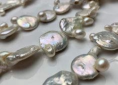 Material : Genuine Freshwater Pearl Quantity : Full Strand- 15.5-16 Inch Shape : Flat Irregular Coin Bead Size: 19 - 21 mm approx. Color : 2 Color Options :- - Natural White ; OR - Natural Seaweed We ship all orders within 24 hours from the U.S. (We closed on Saturday and Sunday) ** We Offer CUSTOM MADE SERVICES and WHOLESALE DISCOUNTS on LARGE QUANTITY PURCHASE. Please convo us on your requirements. We will be happy to create a private listing for you** As the variations in materials, there mig Round Pearl Beads For Jewelry Making, Round Pearl Necklace With Large Beads For Jewelry Making, Round Beaded Necklaces With Pearl Drop For Jewelry Making, Pearl Necklace With Large Round Beads, Pearl Drop Beaded Necklaces With Round Beads, Large Beads Pearl Necklace, Pearl Necklace With Large Beads As Gift, Pearl Necklace With Large Beads For Gift, Large Beads Pearl Necklace As Gift