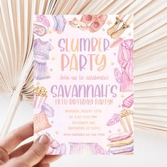 a hand holding up a pink and purple birthday party card that says, slumber party join us to celebrate savannah's fifth birthday party