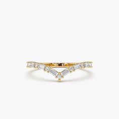 a yellow gold ring with three baguettes on the side and two diamonds in the middle