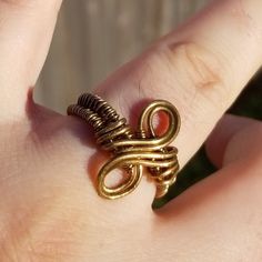 Go for the brass ring! With its subtle infinity symbol and woven band, this unique brass ring is understated but bold. The elegantly curved design would be equally at home at a summer wine festival and a steampunk convention. Handmade and one of a kind, this ring would make a beautiful birthday gift for a teenager, a Valentine's Day gift for your loved one, or a treat for yourself! The minimalist style makes it the perfect subtle accompaniment for any outfit at any occasion. Like what you see, but want a different size or metal choice? Not a problem! Contact me for custom-made jewelry along the same lines. I'm more than happy to work up something more suited to your own personal color palette, or produce another version specifically tailored to the outfit you had in mind. Ships from Boston Handmade Adjustable Infinity Ring, Handmade Minimalist Infinity Rings, Minimalist Handmade Infinity Rings, Gold Copper Promise Ring, Handmade Minimalist Brass Midi Rings, Handmade Minimalist Brass Stackable Rings, Minimalist Adjustable Copper Ring, Adjustable Gold Infinity Stackable Rings, Adjustable Bronze Metal Midi Rings