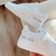 a pair of white sneakers with personalized shoes on them