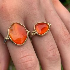 The incredible texture in this striped Rosecut Carnelian is truly one of a kind. Like a flowing river of orange lava it is set in 14k yellow gold with accent beads and a freeform sterling silver band. Approximate stone size: 14mm x 17mm 5.8 cts Mohs Stone Hardness: 6 This one of a kind piece is handmade to in Emily's Hudson Valley studio. This piece is in stock and can be resized prior to shipping. If you have questions about sizing, shipping or need help deciding please reach out to us! Flowing River, Orange Gem, Orange Stone, Local Jewelry, We Can Do It, Gems Jewelry, Sterling Silver Bands, Hudson Valley, Cocktail Ring