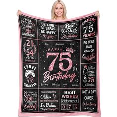 a woman holding up a birthday blanket with the words 75th birthday written on it