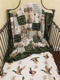 there is a crib bed with ducks on it