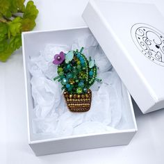 a small potted plant sitting inside of a white box