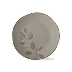 a white and gold plate with leaves on it