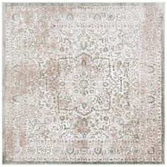 an area rug with various colors and patterns on the floor, including pinks and browns