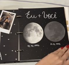 someone is holding an open book with photos on it and the moon in the background