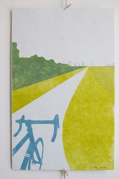 a painting hanging on the side of a wall next to a white wall with a bike painted on it