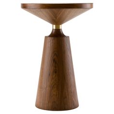 a wooden table with a round top and gold trimmings on the edge, against a white background