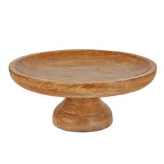 a wooden cake plate sitting on top of a table