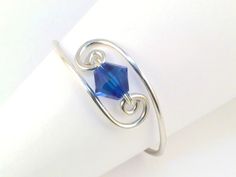 a close up of a ring with a blue stone on it