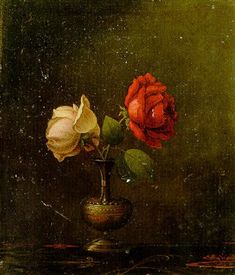 two roses in a vase on a table