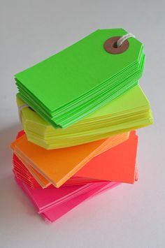 a stack of bright colored paper with a tag on it